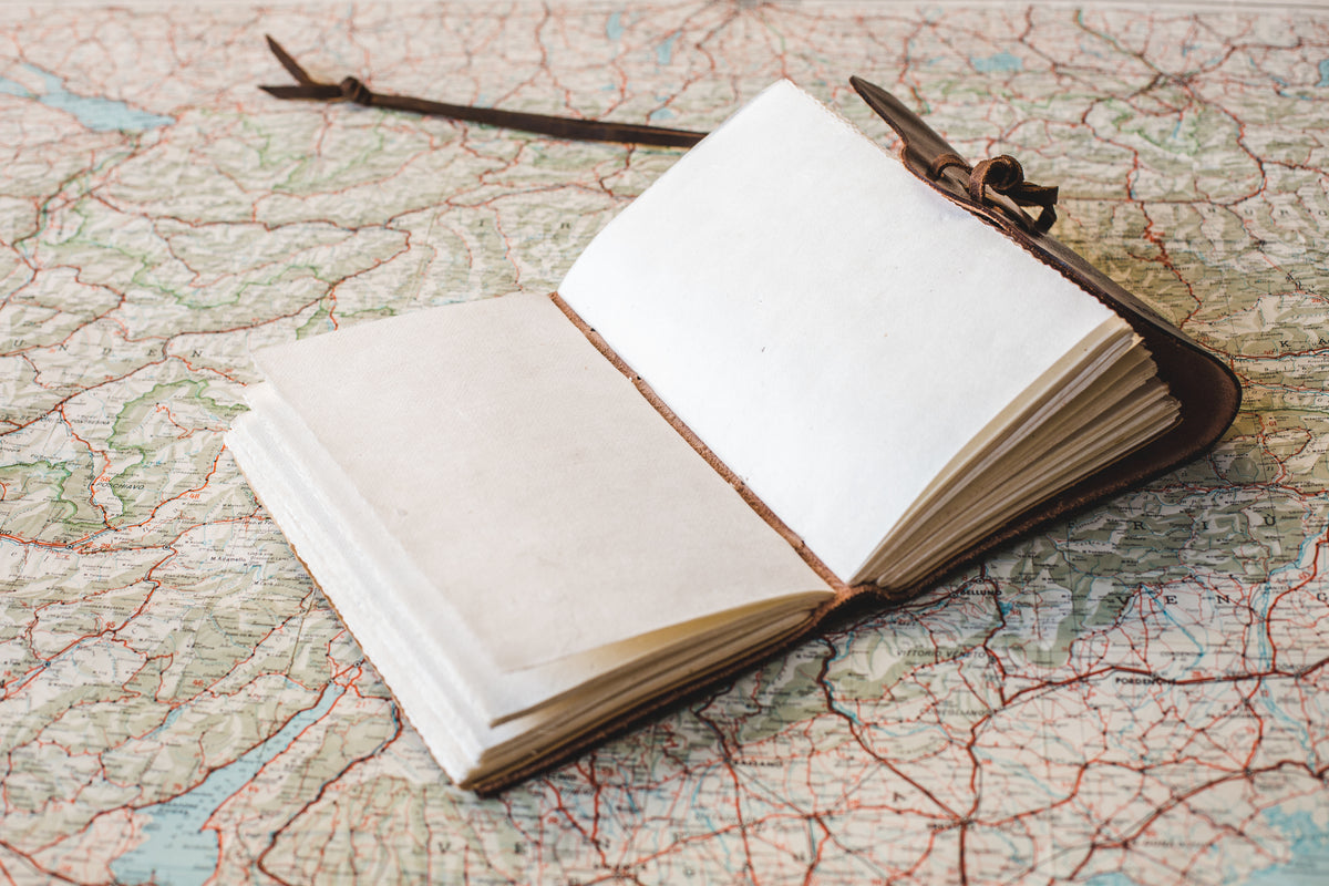 Open notebook with map illustration on desk